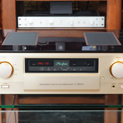 Accuphase precision stereo preamplifier C-3900 with two large gold knobs on a glass shelf, front panel display visible on it